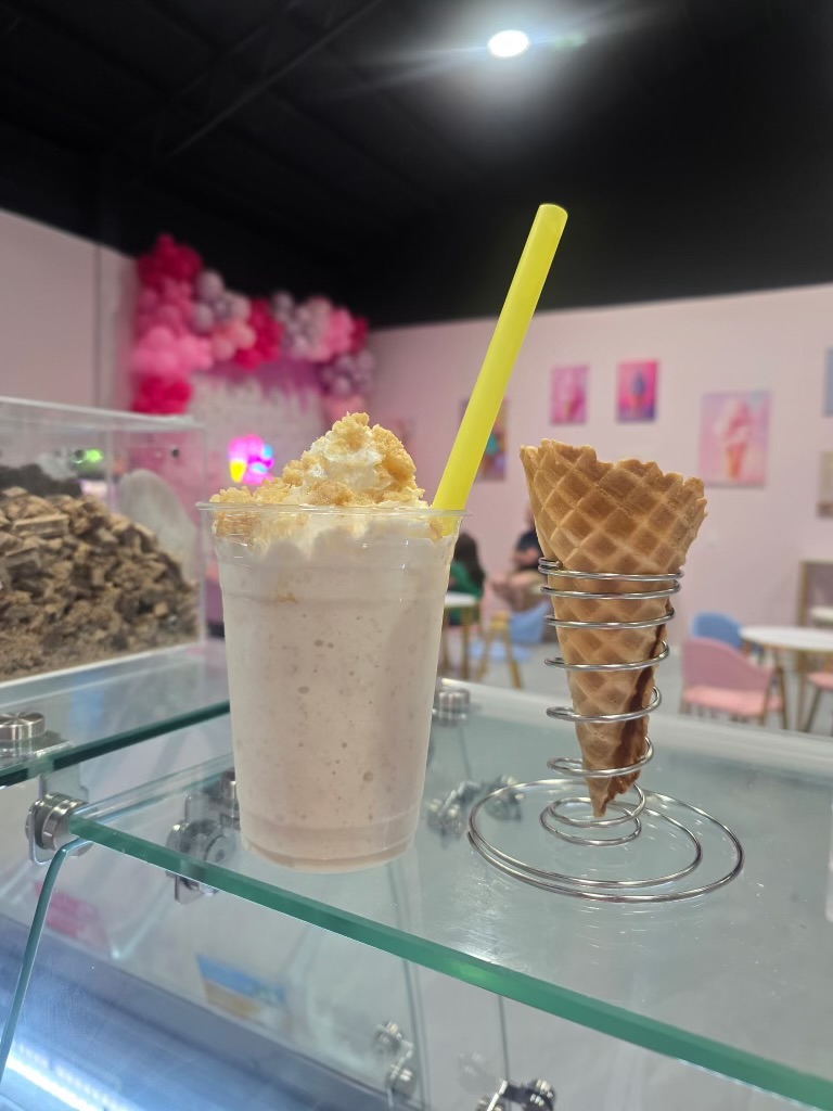 Milkshake with yellow straw and waffle cone at Sweet Swirls